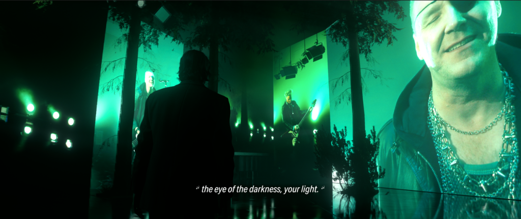 Alan Wake looking at the Old Gods of Asgard band.